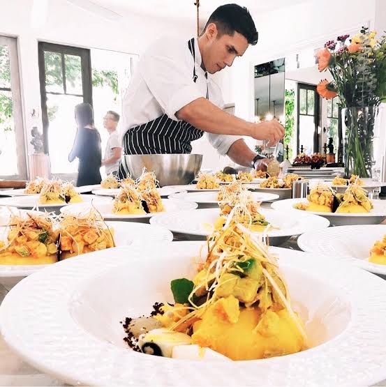 A chef plating dinner